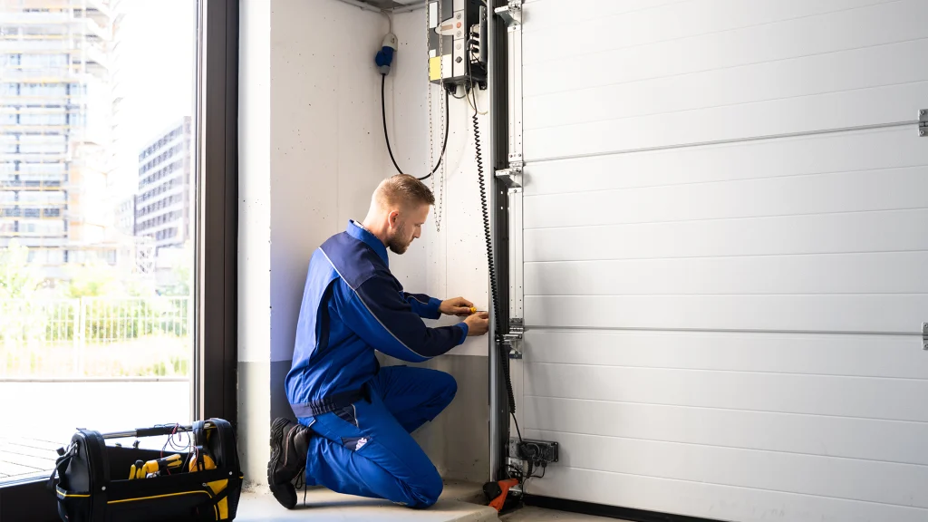 Garage door repair specialist repairing a garage door