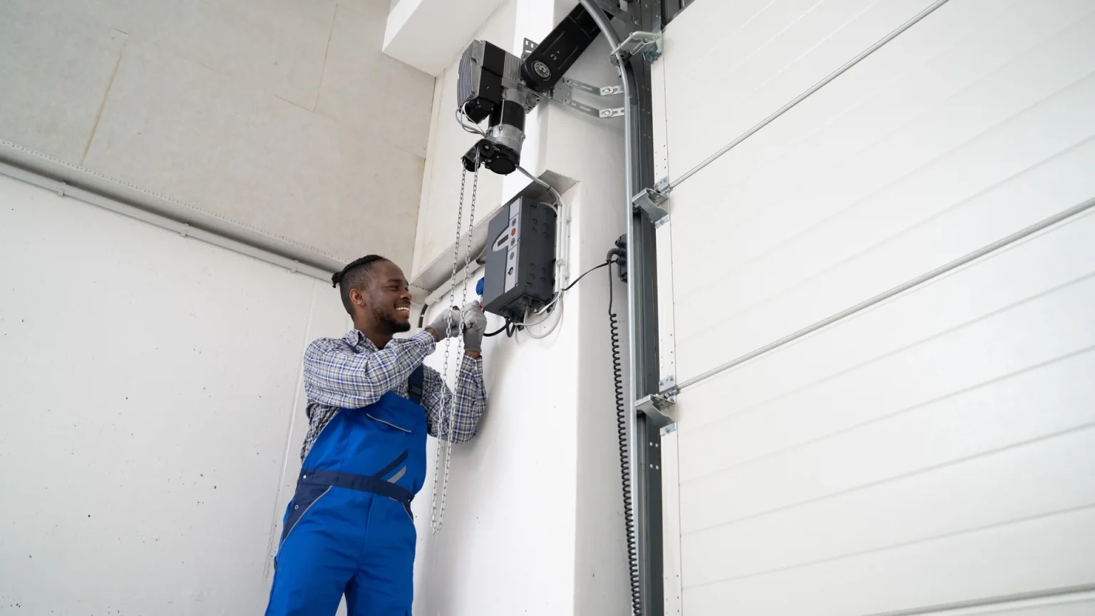 A man maintaining a garage door