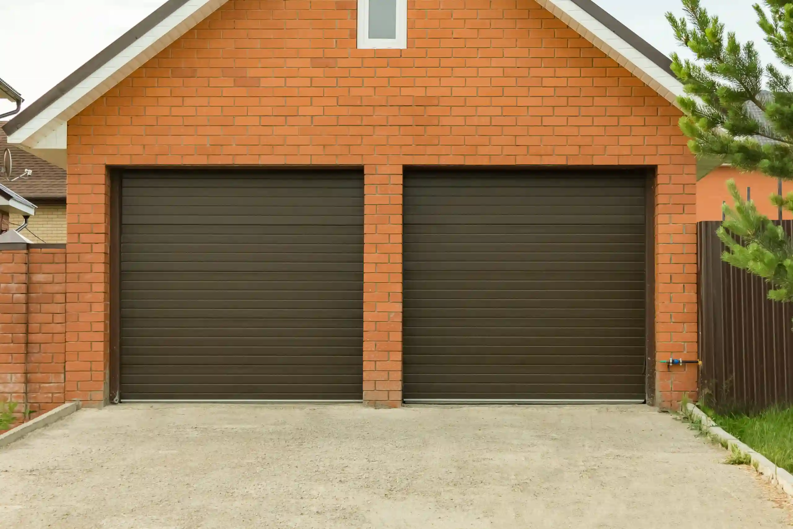 Face brick residential home with dark wood single garage doors