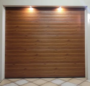 Sectional garage door with a woodlook steel finish in a horizontal slatted design.