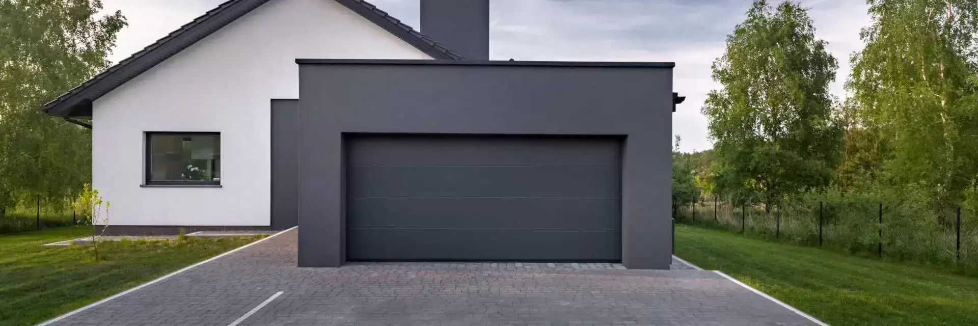 Grey and white house with grey wooden double garage door