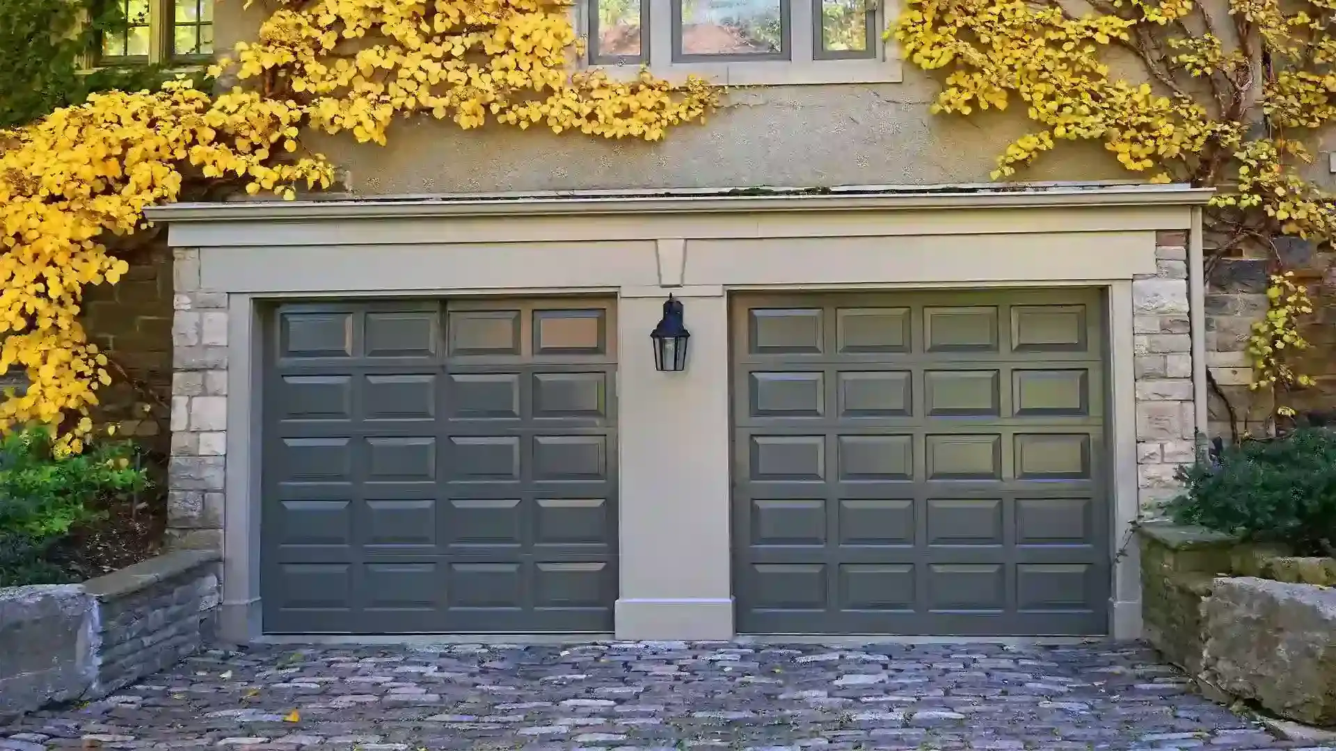 Grey and white house with grey wooden double garage door