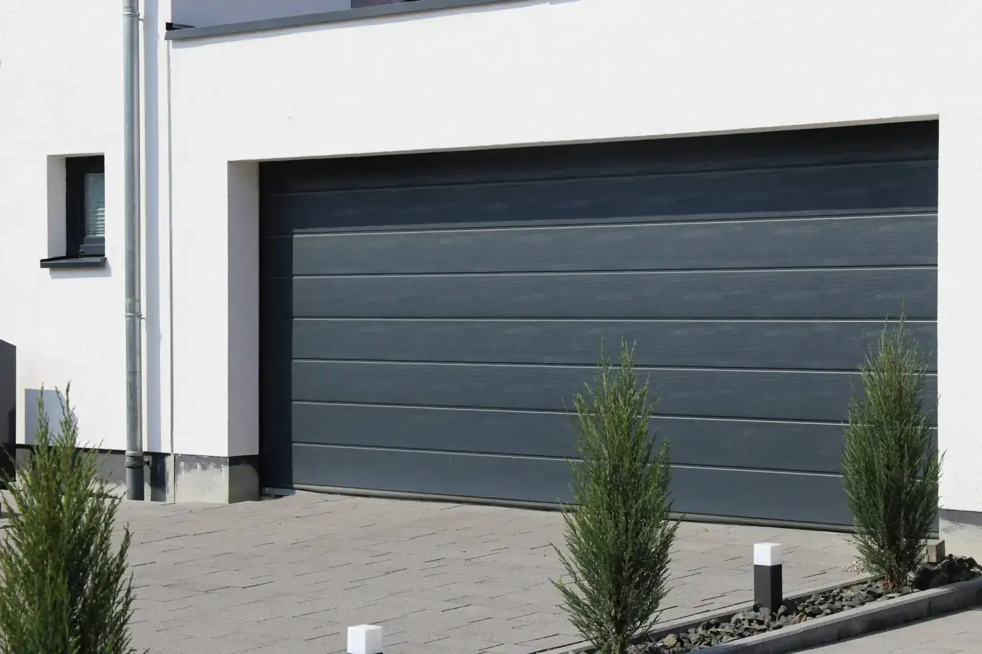 Grey and white house with grey wooden double garage door