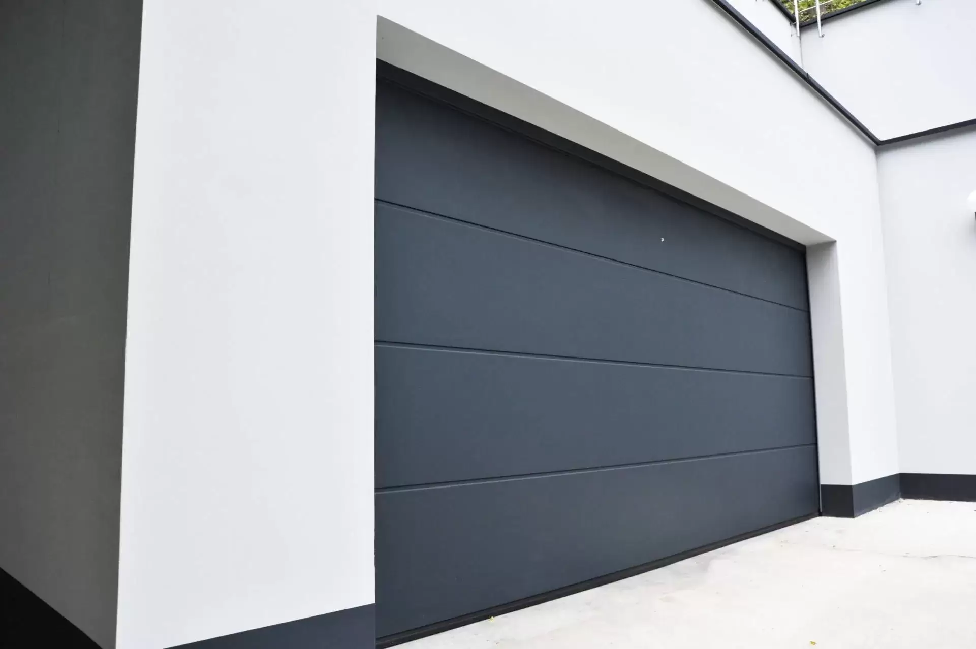 Grey and white house with grey wooden double garage door