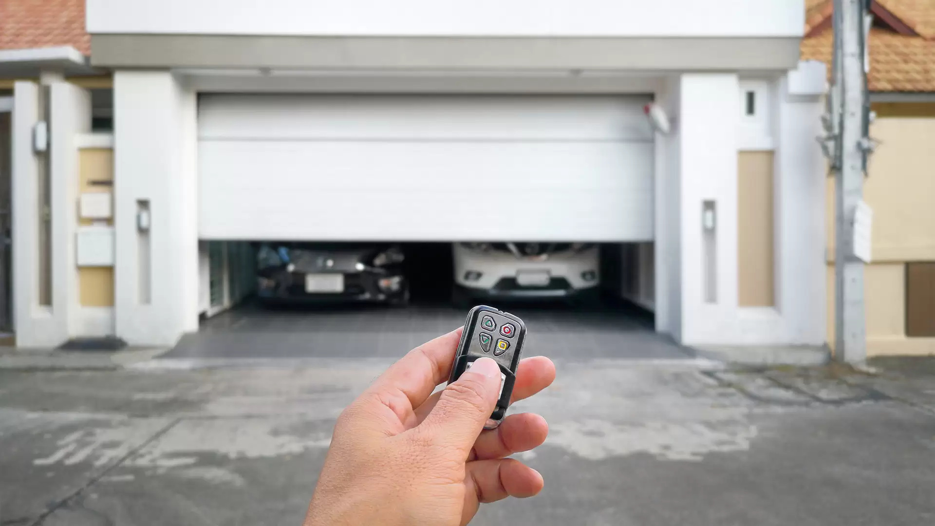 Grey and white house with grey wooden double garage door