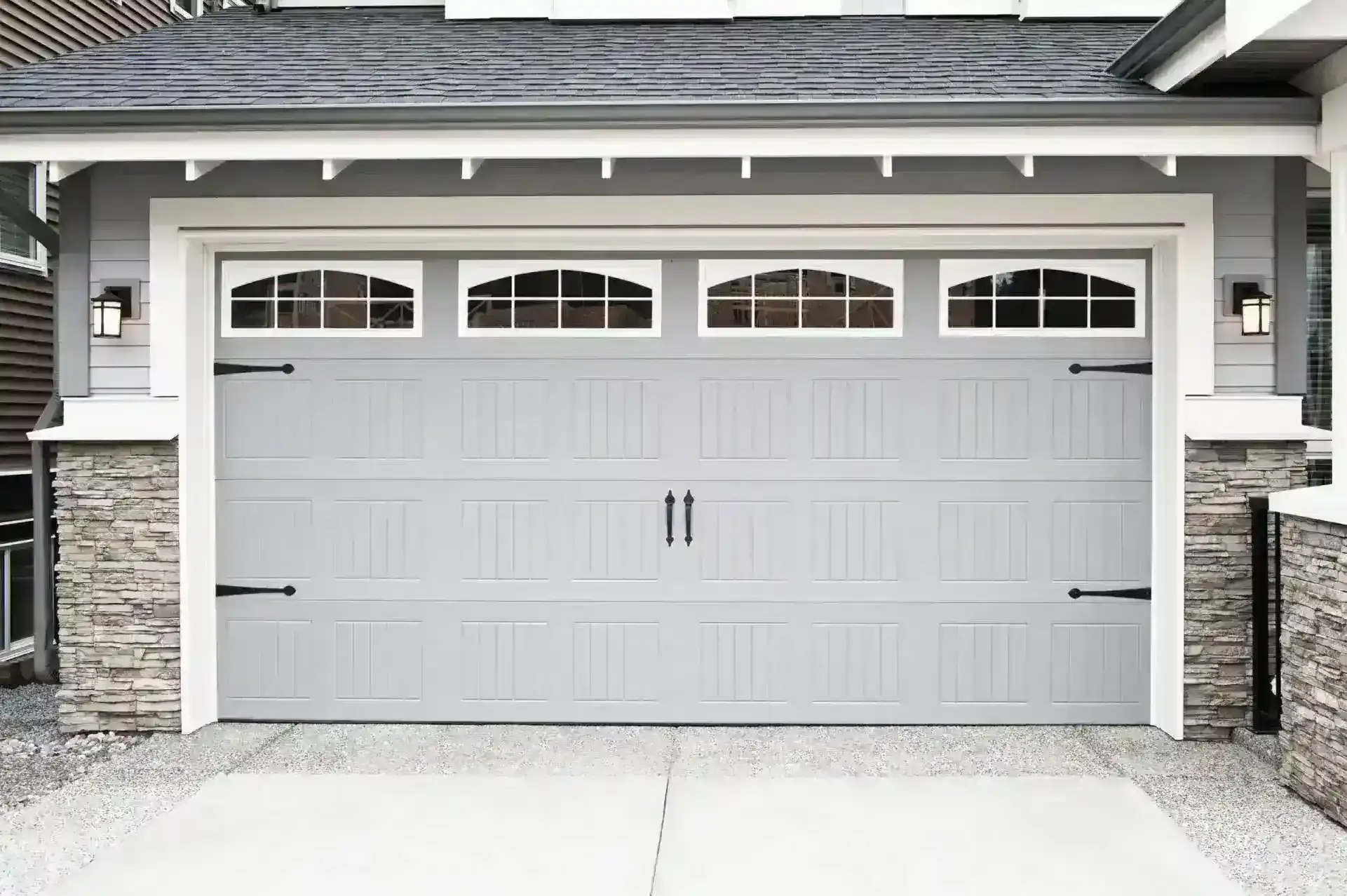 Large grey wooden garage door on a modern house